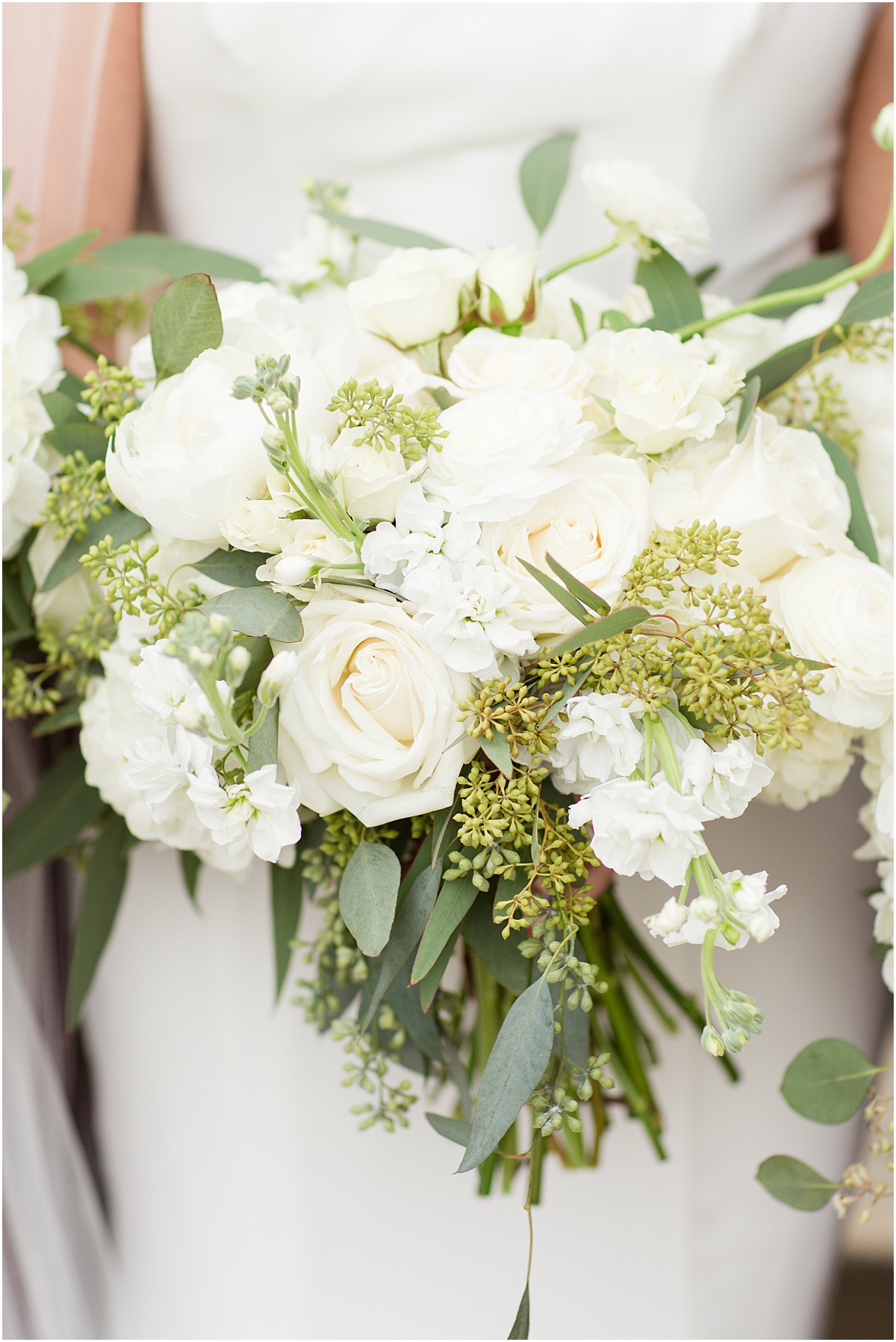 white bride bouquet with roses and greenery