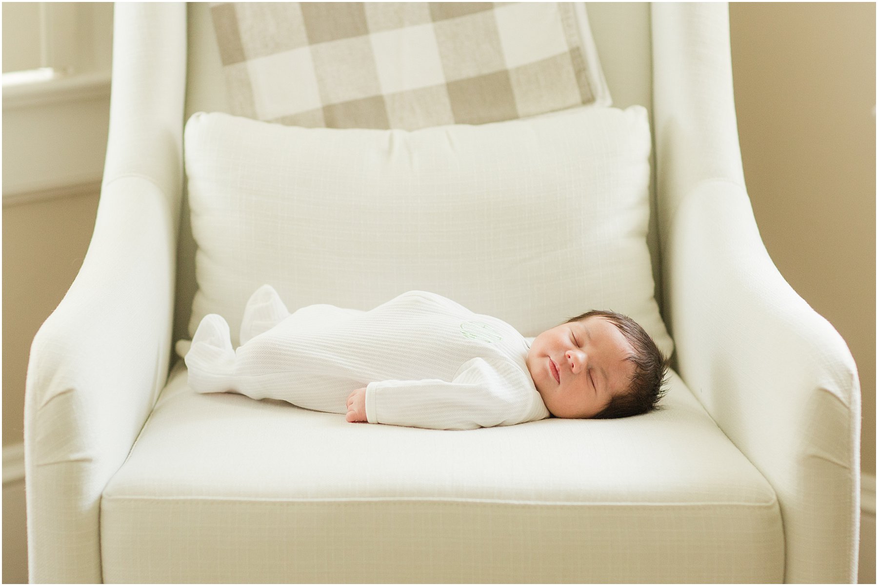 newborn laying on nursery chair